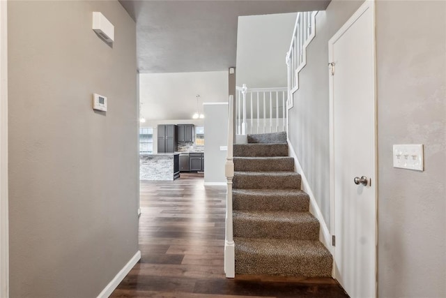 stairs with baseboards and wood finished floors