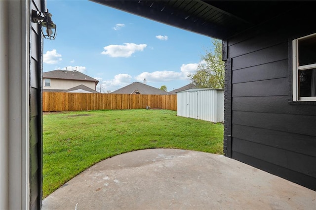 view of yard with a fenced backyard, an outdoor structure, a patio, and a storage shed