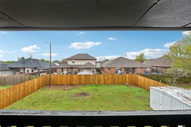 view of yard with a fenced backyard and a residential view