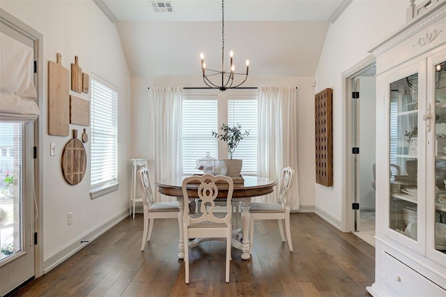 dining area featuring dark wood-style floors, a notable chandelier, lofted ceiling, and visible vents
