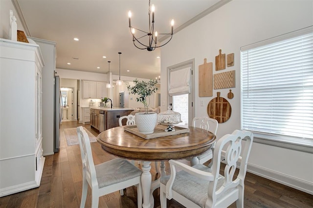 dining area with baseboards, a chandelier, recessed lighting, crown molding, and wood finished floors