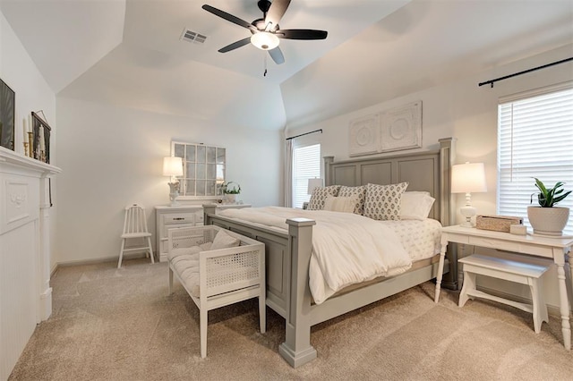 bedroom featuring baseboards, vaulted ceiling, light carpet, a ceiling fan, and visible vents