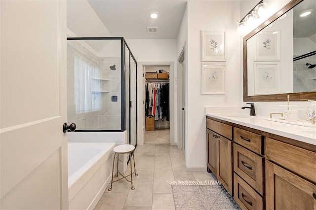 full bathroom featuring double vanity, visible vents, a garden tub, and a stall shower