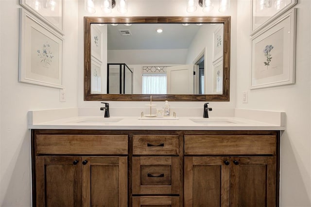 full bath featuring double vanity, a sink, and visible vents