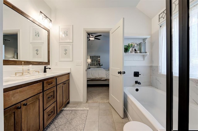 bathroom with a garden tub, connected bathroom, tile patterned flooring, a ceiling fan, and vaulted ceiling