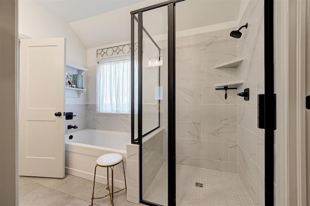 bathroom with a shower stall, tile patterned floors, a garden tub, and lofted ceiling
