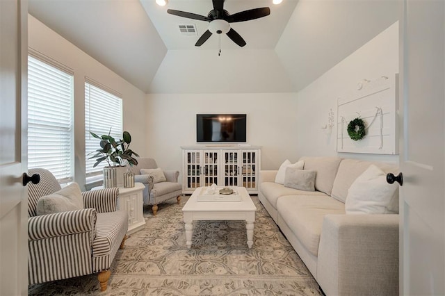 living area with vaulted ceiling, a ceiling fan, and visible vents