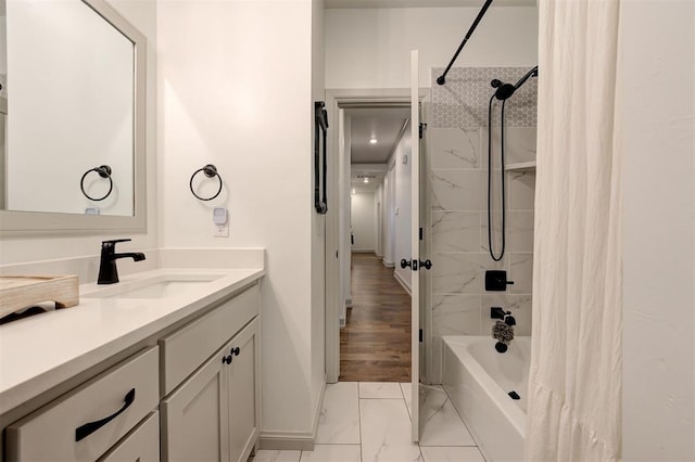 bathroom featuring shower / bath combo, vanity, and marble finish floor