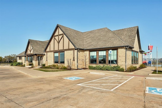 view of property featuring uncovered parking and fence
