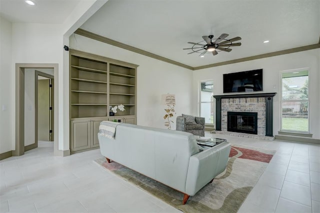 living area featuring a ceiling fan, a brick fireplace, plenty of natural light, and crown molding