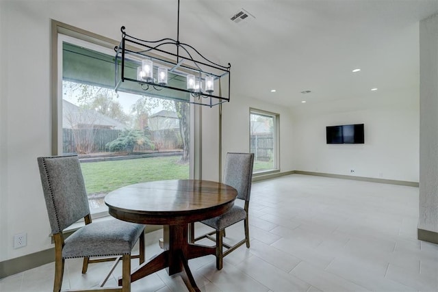 dining area with baseboards, visible vents, recessed lighting, and a notable chandelier