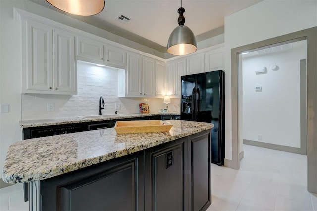 kitchen with white cabinetry, a sink, black appliances, and visible vents