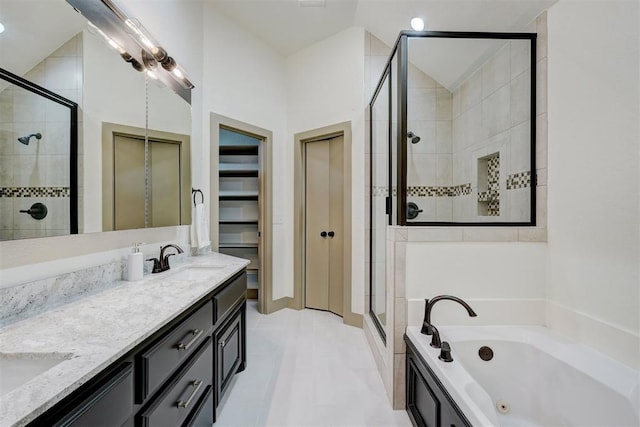 full bath featuring vaulted ceiling, a jetted tub, a sink, a shower stall, and double vanity