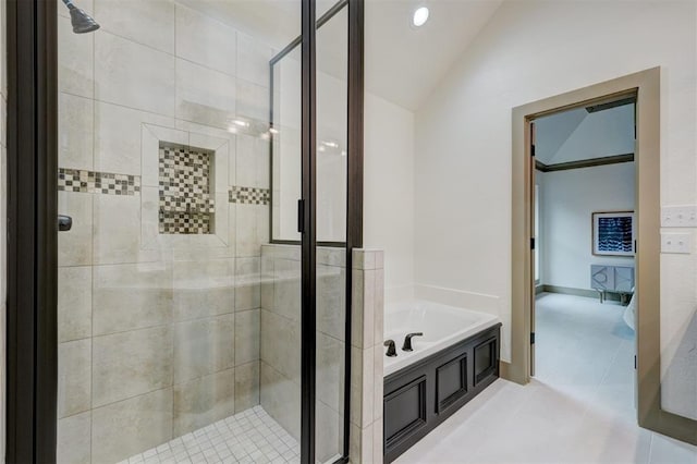 bathroom with lofted ceiling, a garden tub, and a shower stall