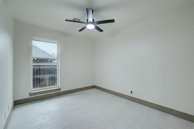 empty room with baseboards and ceiling fan