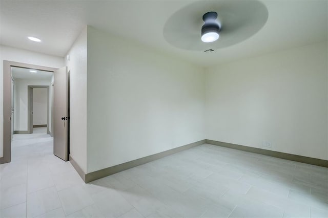 spare room with baseboards and a ceiling fan