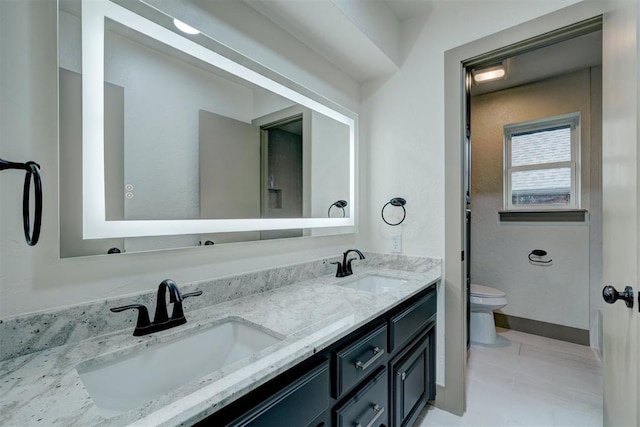 full bath featuring toilet, a sink, and double vanity