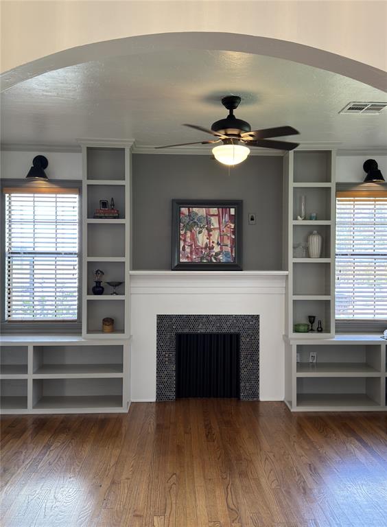 2252 NW 37th St, Oklahoma City, OK 73112 - unfurnished living room featuring a fireplace, plenty of natural light, a ceiling fan, and wood finished floors