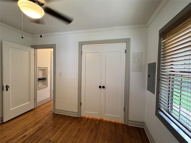 2252 NW 37th St, Oklahoma City, OK 73112 - unfurnished bedroom featuring wood finished floors, electric panel, crown molding, a closet, and ceiling fan