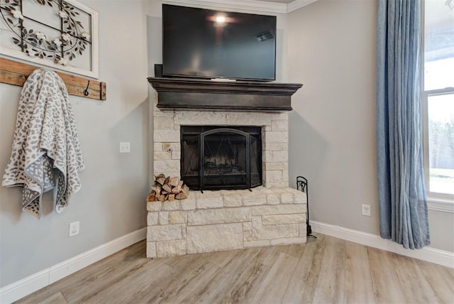 31352 Landrun Ave, Norman, OK 73072 - detailed view of wood finished floors, baseboards, a stone fireplace, and crown molding