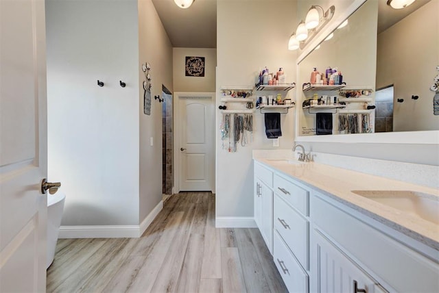 31352 Landrun Ave, Norman, OK 73072 - bathroom with wood finished floors, double vanity, tiled shower, and baseboards