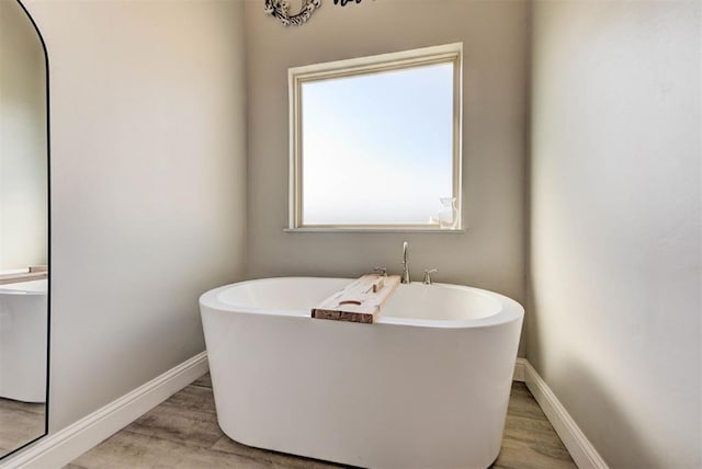31352 Landrun Ave, Norman, OK 73072 - full bath with a freestanding bath, wood finished floors, and baseboards