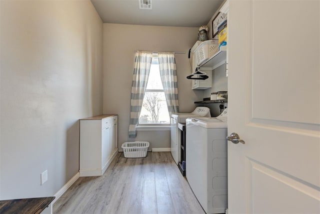 31352 Landrun Ave, Norman, OK 73072 - washroom featuring washing machine and clothes dryer, light wood finished floors, and baseboards