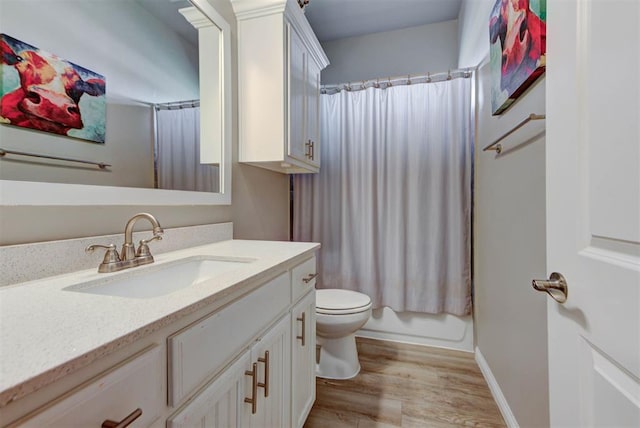 31352 Landrun Ave, Norman, OK 73072 - full bathroom featuring vanity, toilet, wood finished floors, baseboards, and shower / bath combo with shower curtain