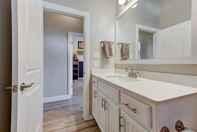 31352 Landrun Ave, Norman, OK 73072 - bathroom with wood finished floors, vanity, and baseboards