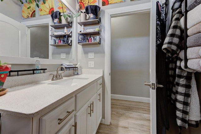 31352 Landrun Ave, Norman, OK 73072 - bathroom featuring baseboards, vanity, and wood finished floors