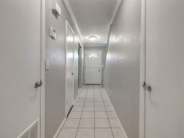 8131 NW 23rd St, Oklahoma City, OK 73127 - hallway with attic access, light tile patterned flooring, baseboards, and ornamental molding