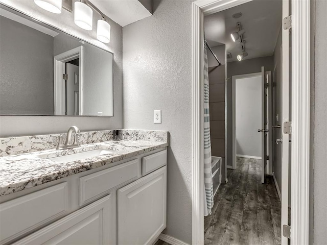 8131 NW 23rd St, Oklahoma City, OK 73127 - bathroom with shower / bath combination with curtain, vanity, and wood finished floors