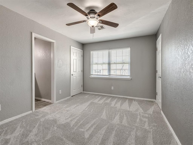 8131 NW 23rd St, Oklahoma City, OK 73127 - unfurnished bedroom featuring ceiling fan, visible vents, carpet flooring, a textured wall, and baseboards