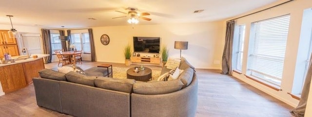1189 N Blue Ridge Dr, Purcell, OK 73080 - living room featuring light wood-style flooring, ceiling fan, baseboards, and visible vents