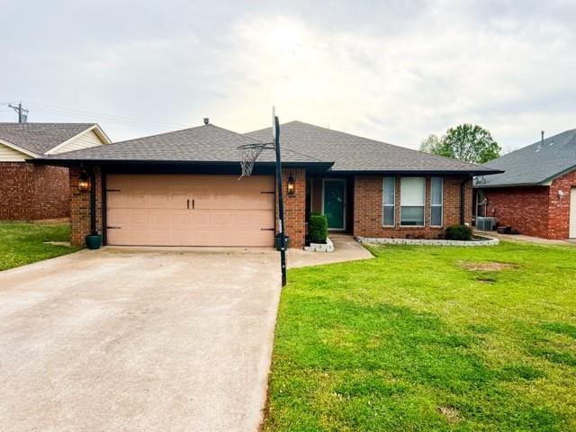 1189 N Blue Ridge Dr, Purcell, OK 73080 - single story home featuring a garage, a front yard, and brick siding