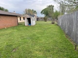 1189 N Blue Ridge Dr, Purcell, OK 73080 - view of yard with a storage shed, an outdoor structure, and fence