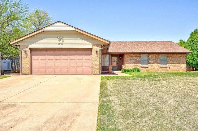 1809 W Aqua Clear Dr, Mustang, OK 73064 - single story home featuring brick siding, a front yard, an attached garage, and concrete driveway