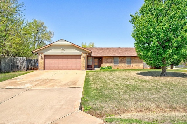 1809 W Aqua Clear Dr, Mustang, OK 73064 - single story home with a front yard, fence, brick siding, an attached garage, and driveway