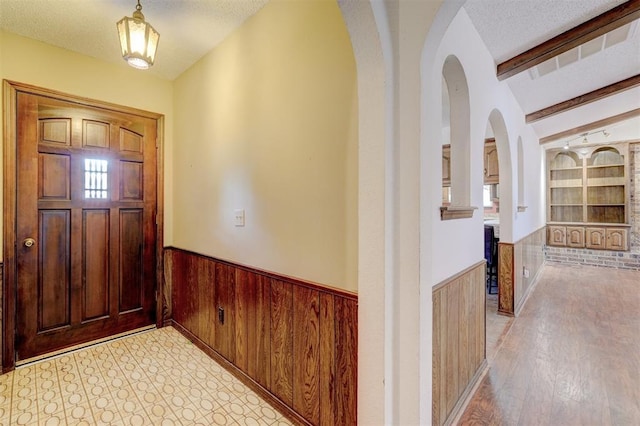 1809 W Aqua Clear Dr, Mustang, OK 73064 - entryway with wainscoting, a textured ceiling, and beam ceiling
