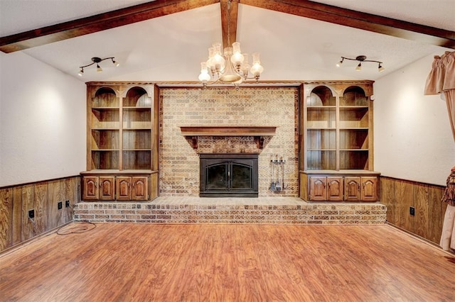 1809 W Aqua Clear Dr, Mustang, OK 73064 - unfurnished living room with wood finished floors, wooden walls, lofted ceiling with beams, and a wainscoted wall