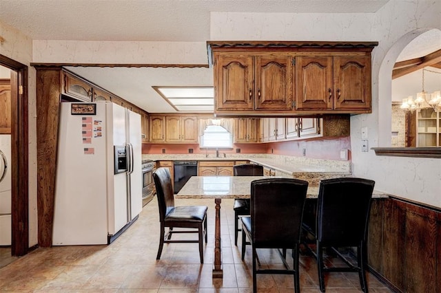 1809 W Aqua Clear Dr, Mustang, OK 73064 - kitchen featuring an inviting chandelier, white fridge with ice dispenser, a peninsula, stainless steel gas range, and a sink