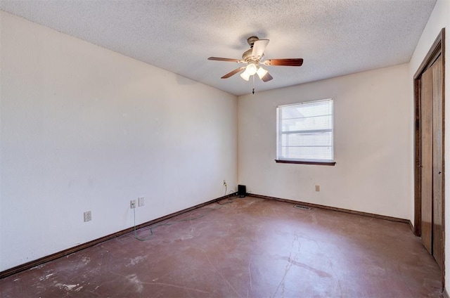 1809 W Aqua Clear Dr, Mustang, OK 73064 - unfurnished bedroom with concrete floors, visible vents, baseboards, a ceiling fan, and a textured ceiling