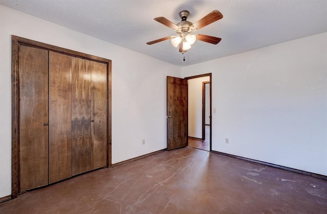 1809 W Aqua Clear Dr, Mustang, OK 73064 - unfurnished bedroom with a closet, concrete floors, a textured ceiling, and baseboards