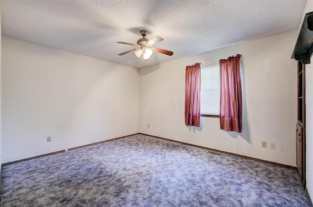 1809 W Aqua Clear Dr, Mustang, OK 73064 - spare room with a textured ceiling, carpet flooring, baseboards, and a ceiling fan