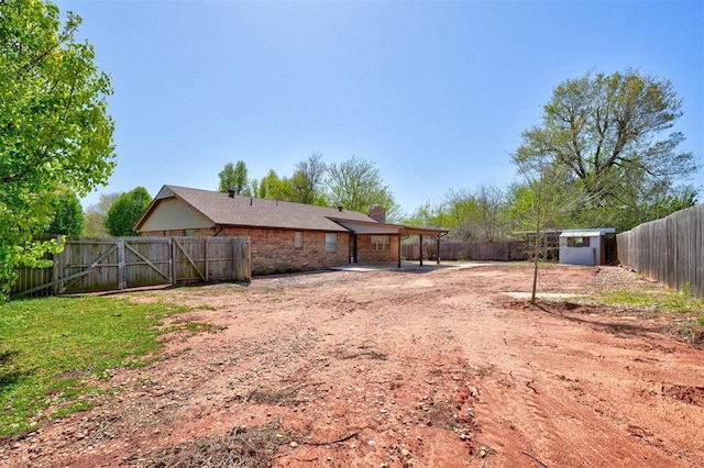 1809 W Aqua Clear Dr, Mustang, OK 73064 - view of yard with an outbuilding, a fenced backyard, a storage unit, and a patio area