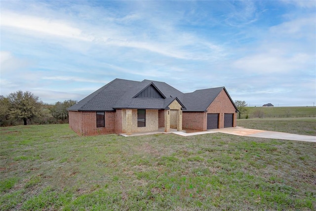2040 County Road 1336, Blanchard, OK 73010 - view of front of property with board and batten siding, a garage, a front yard, brick siding, and driveway