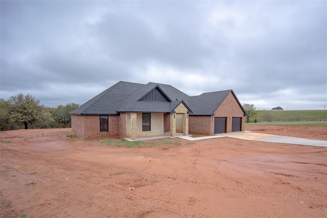 2040 County Road 1336, Blanchard, OK 73010 - view of front of property with brick siding, an attached garage, and concrete driveway