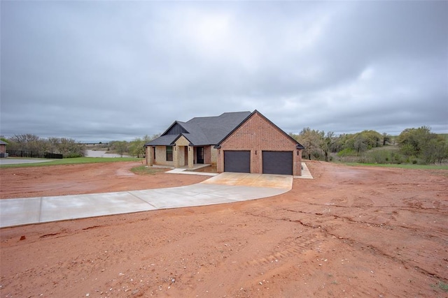 2040 County Road 1336, Blanchard, OK 73010 - view of front of house with brick siding, driveway, and a garage