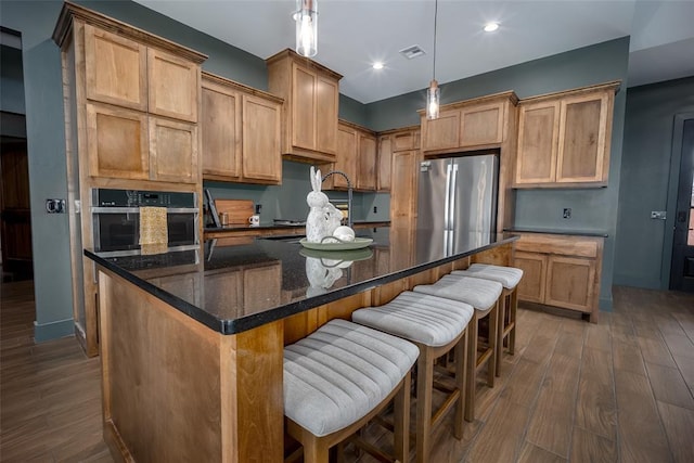 2040 County Road 1336, Blanchard, OK 73010 - kitchen featuring a center island, visible vents, dark wood-style flooring, and appliances with stainless steel finishes