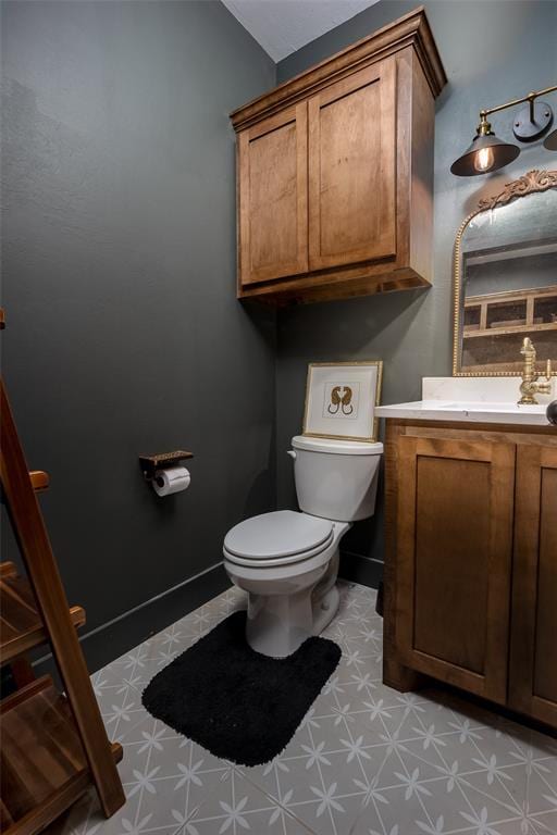 2040 County Road 1336, Blanchard, OK 73010 - half bathroom featuring tile patterned floors, toilet, vanity, and baseboards